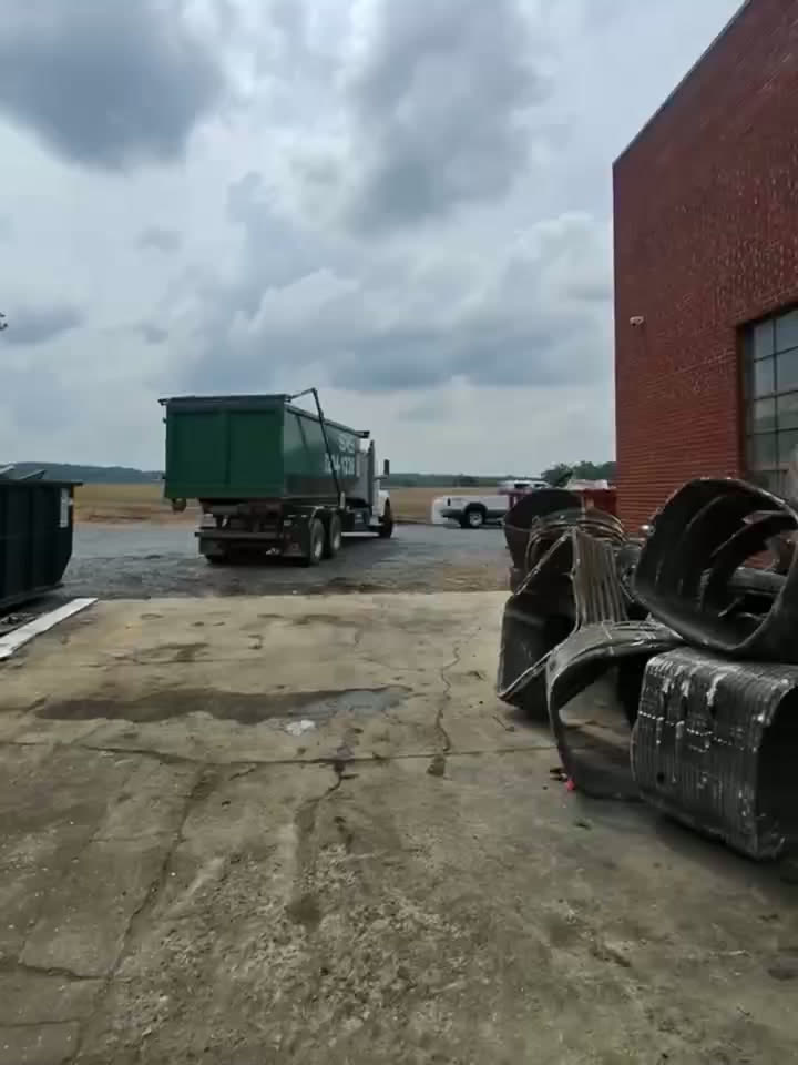 Copper Brokers dumpster truck on a job site