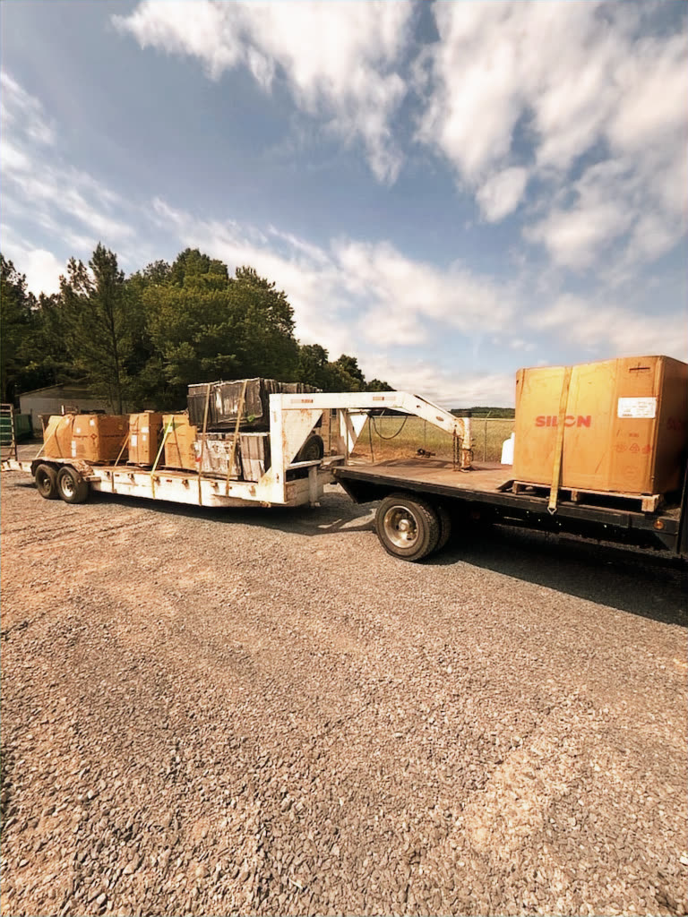 Flatbed trailer transporting crated HVAC equipment